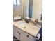 Bathroom vanity with a decorative stone countertop and a modern black faucet at 19014 N 91St Dr, Peoria, AZ 85382