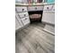 Bathroom vanity with storage beneath and grey wood-look flooring in bathroom at 19014 N 91St Dr, Peoria, AZ 85382