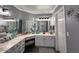 Bathroom boasts double sinks, an array of mirrors, and a seated vanity at 19014 N 91St Dr, Peoria, AZ 85382