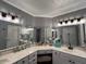 Bathroom boasts double sinks, an array of mirrors, and a seated vanity at 19014 N 91St Dr, Peoria, AZ 85382