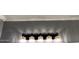 Bathroom light fixture with five lights and black and gold hardware on grey wall at 19014 N 91St Dr, Peoria, AZ 85382