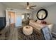 Bright bedroom with daybed, mirrored closet, round mirror, and tufted ottoman at 19014 N 91St Dr, Peoria, AZ 85382