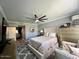 Comfortable bedroom boasts large windows, soft carpeting, and a ceiling fan at 19014 N 91St Dr, Peoria, AZ 85382
