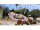 Unique community clock with floral design surrounded by desert landscaping in a vibrant outdoor setting at 19014 N 91St Dr, Peoria, AZ 85382
