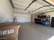 Spacious two-car garage with ample storage, well-lit, and featuring epoxy flooring at 19014 N 91St Dr, Peoria, AZ 85382