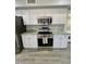 Well-equipped kitchen with stainless steel appliances, granite countertops, and white cabinets at 19014 N 91St Dr, Peoria, AZ 85382