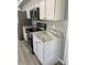 Modern kitchen with stainless steel appliances, granite countertops and white cabinets at 19014 N 91St Dr, Peoria, AZ 85382