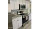 Bright kitchen with stainless steel appliances, granite countertops and white cabinets at 19014 N 91St Dr, Peoria, AZ 85382