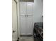Laundry room with storage closet and modern black washer and dryer units at 19014 N 91St Dr, Peoria, AZ 85382