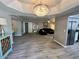 Spacious living room featuring hardwood floors and decorative lighting fixture at 19014 N 91St Dr, Peoria, AZ 85382