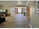 Bright living room featuring wood-look floors, open layout, and neutral paint at 19014 N 91St Dr, Peoria, AZ 85382