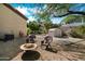 Cozy backyard fire pit area with comfortable seating and a storage shed, surrounded by gravel and desert landscaping at 1922 E Everett Dr, Phoenix, AZ 85022