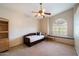 Bedroom featuring a daybed, mounted wall shelf, a ceiling fan, and window with shutter at 1922 E Everett Dr, Phoenix, AZ 85022