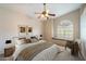 Inviting bedroom boasts a ceiling fan, arch window, and comfortable reading nook at 1922 E Everett Dr, Phoenix, AZ 85022