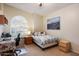 Comfortable bedroom with window bench seating, a cityscape art piece, and a side table at 1922 E Everett Dr, Phoenix, AZ 85022