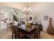 Open dining area with a large table, chandelier, and staircase in the background at 1922 E Everett Dr, Phoenix, AZ 85022