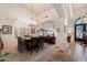 Elegant dining room with a large table, chandelier, and access to other living spaces at 1922 E Everett Dr, Phoenix, AZ 85022