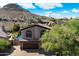 Beautiful two-story home featuring stone accents, arched windows, desert landscaping, and tile roof at 1922 E Everett Dr, Phoenix, AZ 85022