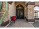 Home's entrance features an iron gate, a stone facade, and a custom door at 1922 E Everett Dr, Phoenix, AZ 85022