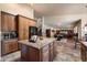Open concept kitchen with granite countertops, wooden cabinetry, and a large island at 1922 E Everett Dr, Phoenix, AZ 85022