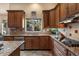 Well-equipped kitchen with wooden cabinets, granite countertops, and stainless steel appliances at 1922 E Everett Dr, Phoenix, AZ 85022