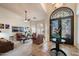 Bright living room featuring an iron gate front door, tile floors, and ample natural light at 1922 E Everett Dr, Phoenix, AZ 85022