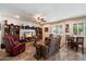 Inviting living room with a sectional sofa, shelving, shutters, and a ceiling fan at 1922 E Everett Dr, Phoenix, AZ 85022