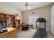 A functional office area featuring a treadmill, desk, shelves, chair, and white wall paneling at 1922 E Everett Dr, Phoenix, AZ 85022