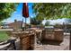 Outdoor kitchen featuring a stone counter, built-in grill, and ample space for entertaining at 1922 E Everett Dr, Phoenix, AZ 85022