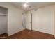 Bedroom featuring a ceiling fan, closet and wood floors at 19251 N 17Th Dr, Phoenix, AZ 85027