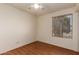 Neutral bedroom featuring wood floors and a view of the backyard through the window at 19251 N 17Th Dr, Phoenix, AZ 85027