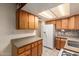 Kitchen with light wood cabinets, white appliances, and tiled floors at 19251 N 17Th Dr, Phoenix, AZ 85027