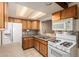This kitchen has wood cabinets, granite countertops, and stainless appliances at 19251 N 17Th Dr, Phoenix, AZ 85027