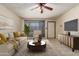 Bright living room with tile floors, a plush sofa, a modern console, and large windows offering scenic outdoor views at 19251 N 17Th Dr, Phoenix, AZ 85027
