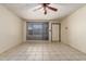 Inviting living room featuring neutral tile floors, ceiling fan, and large windows, ready for personalization at 19251 N 17Th Dr, Phoenix, AZ 85027
