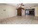 Open living space featuring neutral tile floors, bright kitchen and a cozy fireplace at 19251 N 17Th Dr, Phoenix, AZ 85027