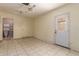 Neutral living room featuring tile floors, a ceiling fan, and access to a small bathroom at 19251 N 17Th Dr, Phoenix, AZ 85027