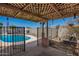 Backyard pool with open gate to patio and lattice shade cover, surrounded by desert landscaping at 19251 N 17Th Dr, Phoenix, AZ 85027