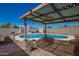 A backyard swimming pool and covered patio offer shade and fun in this desert oasis at 19251 N 17Th Dr, Phoenix, AZ 85027