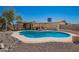 An inviting in-ground pool surrounded by desert landscaping offers a refreshing retreat in the backyard at 19251 N 17Th Dr, Phoenix, AZ 85027