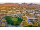 Scenic aerial of a golf course community with homes and mountain views in the background at 19475 N Grayhawk Dr # 1039, Scottsdale, AZ 85255