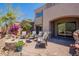 Beautiful backyard featuring a stone fire pit, comfortable seating, and lush desert landscaping at 19475 N Grayhawk Dr # 1039, Scottsdale, AZ 85255