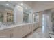 Bright bathroom with dual sinks, marble countertops, and full-length mirrors for a spacious feel at 19475 N Grayhawk Dr # 1039, Scottsdale, AZ 85255
