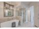 Elegant bathroom with a soaking tub and walk-in shower, enhanced by stylish lighting fixtures at 19475 N Grayhawk Dr # 1039, Scottsdale, AZ 85255
