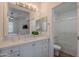 Bright bathroom with double sinks, white cabinets, and a shower/tub combo, plus a view to bedroom at 19475 N Grayhawk Dr # 1039, Scottsdale, AZ 85255