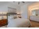 Bright bedroom featuring wood floors, a ceiling fan, and an ensuite bathroom with double sinks at 19475 N Grayhawk Dr # 1039, Scottsdale, AZ 85255