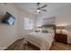 Cozy bedroom with wood floors, ceiling fan, and modern decor. Large bed and neutral color palette at 19475 N Grayhawk Dr # 1039, Scottsdale, AZ 85255