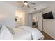 Bedroom with wood floors and neutral decor; ensuite bathroom and view into living area at 19475 N Grayhawk Dr # 1039, Scottsdale, AZ 85255