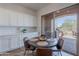 Bright breakfast nook with a round table and chairs, adjacent to the outdoor patio and kitchen at 19475 N Grayhawk Dr # 1039, Scottsdale, AZ 85255