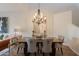 Elegant dining room with stylish chairs, wood floors and chandelier at 19475 N Grayhawk Dr # 1039, Scottsdale, AZ 85255
